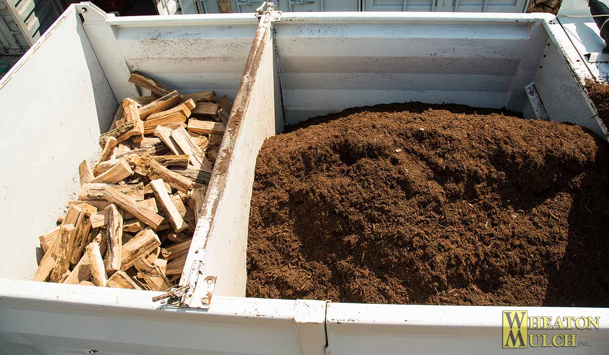 Firewood on one side of the divider and mulch on the other, loaded in a single truck